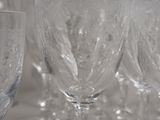 many wine glasses lined up on a table