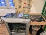 a small tv that is sitting on the floor next to a bed