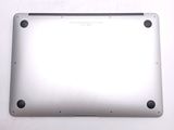 the back of a silver laptop computer sitting on top of a white surface