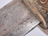 a close up of a knife with a metal handle