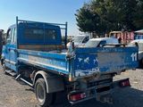 a blue truck that is parked in a lot