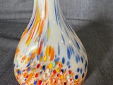a glass vase with a multicolored design on it
