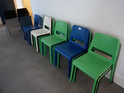 many chairs lined up in a row against a wall