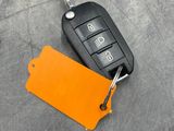 an image of a car key with a tag attached to it