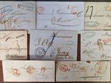 many old envelopes with stamps on them sitting on a table