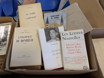 many books in a box that are sitting on a table