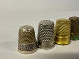 three different types of thimbles are lined up on a white surface
