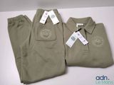 two men ' s polo shirts and pants are on a table