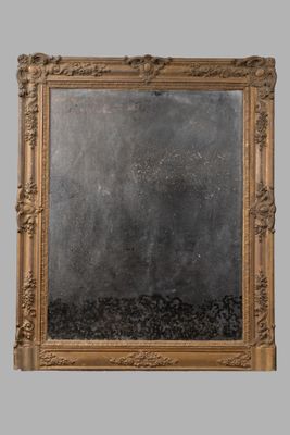an image of a mirror with a gold frame on a gray wall