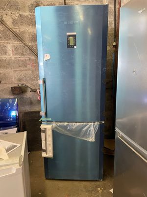 two refrigerators that are sitting in a room