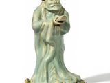 a figurine of a man with a hat and a cane