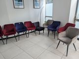 several chairs are lined up in a row in a waiting room