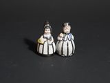 pair of salt and pepper shakers in black and white striped gowns