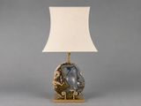 a table lamp with a white shade on top of it