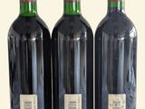 three bottles of wine sitting next to each other on a table