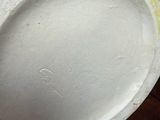 a close up of a white plate on a wooden table