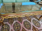 a coffee table with a glass top sitting on a rug