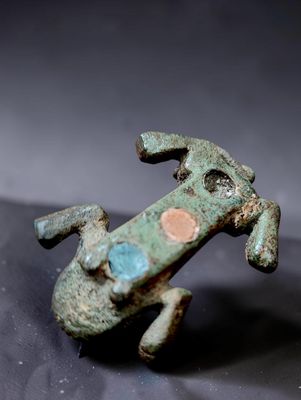 a figurine of a dog that is sitting on a table