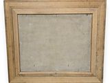 an old wooden frame with a mirror hanging on the wall