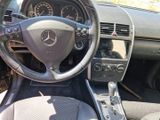 a steering wheel and dashboard of a car in a parking lot