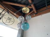 a clock hanging from the ceiling of a restaurant
