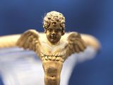 a statue of a man with wings on top of a vase