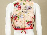 a mannequin wearing a floral vest on a mannequin