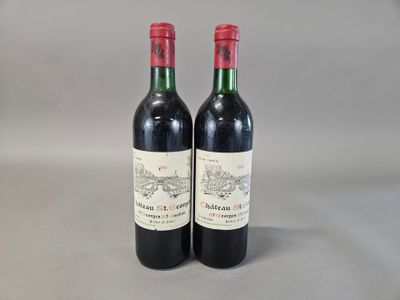 two bottles of red wine sitting next to each other on a table