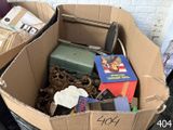 a cardboard box filled with books and other items