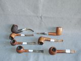 several different types of pipes are lined up on a table