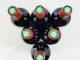 bottles of wine are arranged in a star shape on a white surface