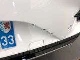 a close up of a white car with a number 33 on it