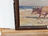 a picture of a painting of a cow on a shelf