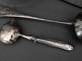 two spoons and a spoon rest on a table