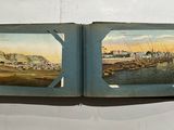 two open books with pictures of a city on them