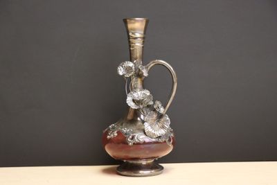 un vase en argent posé sur une table en bois
