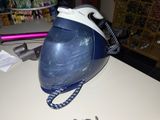 a blue and white steam iron sitting on a counter