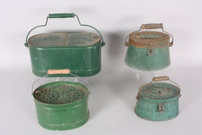three green metal buckets with handles and handles on a white surface