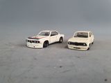 two toy cars sitting next to each other on a table