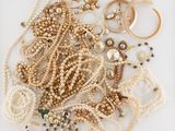a pile of pearls and other jewelry on a table