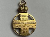 a close up of a gold medal with a crown on it