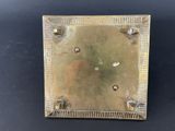 a close up of a metal object on a black surface
