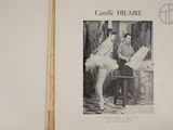 an old photo of a man and woman in tutuss sitting on a chair