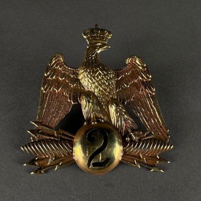 an image of a gold eagle badge with a number 2 on it