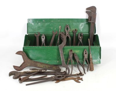 many tools in a green box on a white surface