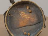 a small metal object sitting on a wooden table
