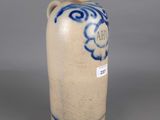 a blue and white vase sitting on a gray surface