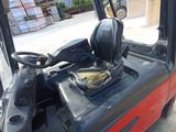 a fork lift truck with a seat on the back of it
