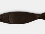 a brown fish shaped object on a white surface