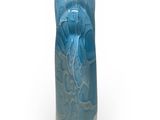 a blue vase that is sitting on a white surface
